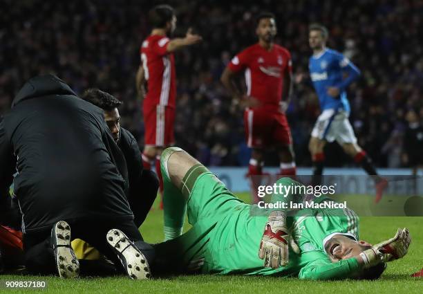 JJoe Lewis of Aberdeen receives treatment after he brings down Josh Windass of Rangers during the Ladbrokes Scottish Premiership match between...