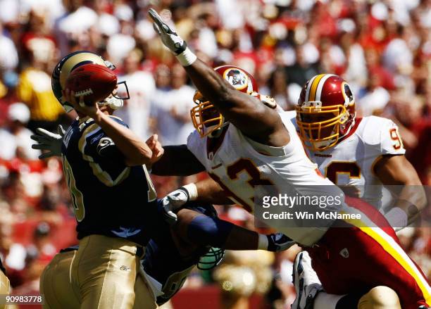 Mark Bulger of the St. Louis Rams tries to avoid Phillip Daniels of the Washington Redskins during their game on September 20, 2009 at FedEx Field in...