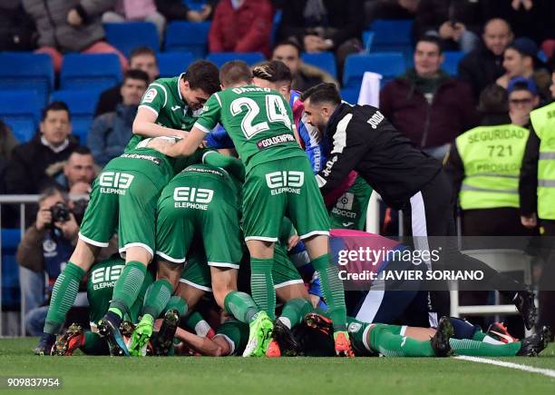 Leganes players celebrate their second goal during the Spanish 'Copa del Rey' quarter-final second leg football match between Real Madrid CF and CD...