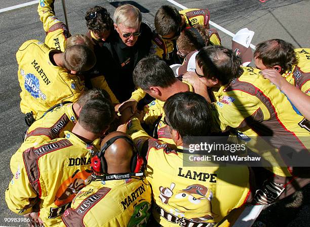 Team owner Joe Gibbs talks with the M&M's crew before the NASCAR Sprint Cup Series Sylvania 300 at the New Hampshire Motor Speedway on September 20,...