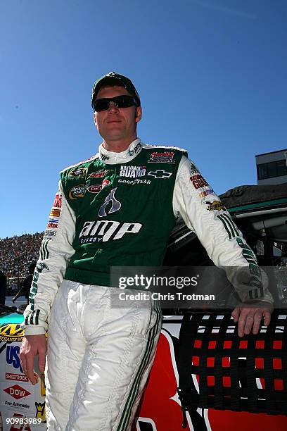 Dale Earnhardt Jr., driver of the AMP Energy/National Guard Chevrolet, stands on pit lane before the NASCAR Sprint Cup Series Sylvania 300 at the New...