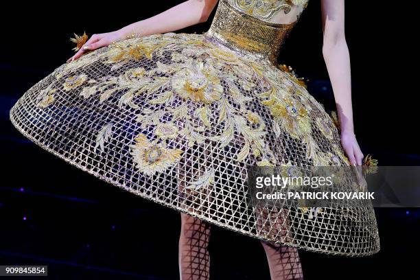 Model presents a creation by Guo Pei during the 2018 spring/summer Haute Couture collection fashion show on January 24, 2018 in Paris. / AFP PHOTO /...