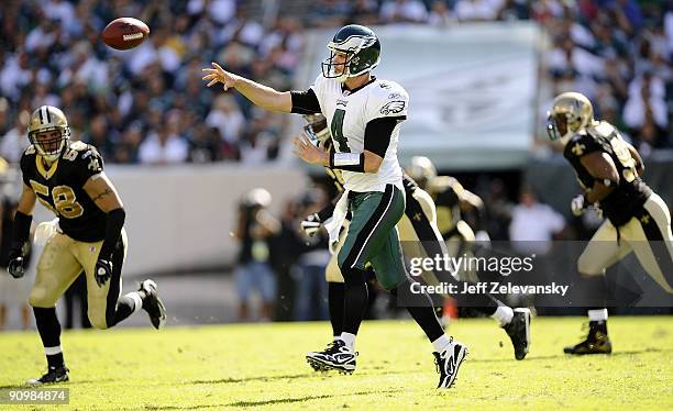 Kevin Kolb of the Philadelphia Eagles passes under pressure from the Scott Shanle of the New Orleans Saints during their game at Lincoln Financial...