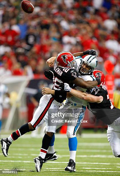 Erik Coleman and Kroy Biermann of the Atlanta Falcons break up a pass by quarterback Jake Delhomme of the Carolina Panthers at Georgia Dome on...