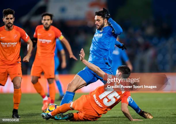 Jorge Molina Vidal of Getafe CF fights for the ball with Federico Ricca Rostagnol of Malaga CF during the La Liga 2017-18 match between Getafe CF and...