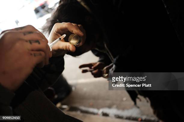 Man uses heroin under a bridge where he lives with other addicts in the Kensington section which has become a hub for heroin use on January 24, 2018...