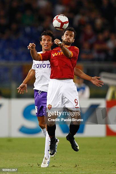 Mirko Vucinic of AS Roma and Alessandro Gamberini of ACF Fiorentina compete fo for the ball during the Serie A match between AS Roma and ACF...