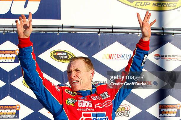 Mark Martin, driver of the CARQUEST/Kellogg's Chevrolet, celebrates in victory lane after winnng the NASCAR Sprint Cup Series Sylvania 300 at the New...