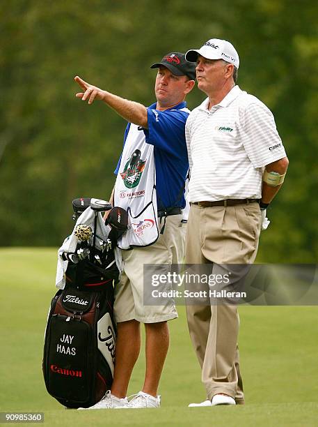 Jay Haas chats with his caddie Tommy Lamb on the 16th hole during the final round of the Greater Hickory Classic at the Rock Barn Golf & Spa on...