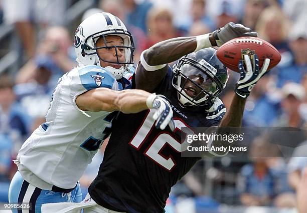 Jacoby Jones of the Houston Texans catches a touchdown pass while defended by Cortland Finnegan of the Tennessee Titans during the NFL game at LP...