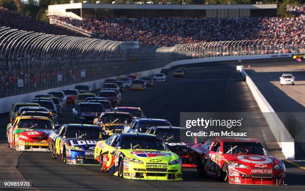 Mark Martin , driver of the CARQUEST/Kellogg's Chevrolet, and Juan Pablo Montoya , driver of the Target Chevrolet, lead the field late in the race...