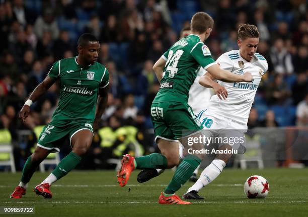 Marcos Llorente of Real Madrid in action against Claudio Beauvue and Darko Brasanac of Leganes during the Copa del Rey quarter final match between...