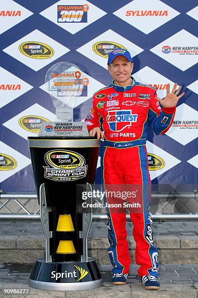 Mark Martin, driver of the CARQUEST/Kellogg's Chevrolet, celebrates with the trophy in victory lane after winning the NASCAR Sprint Cup Series...