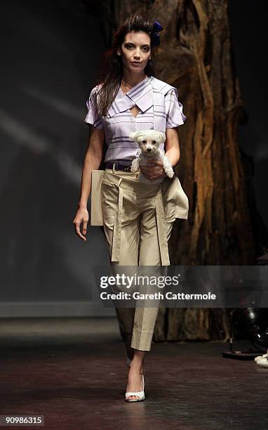 Daisy Lowe and her dog walk down the runway during the Vivienne Westwood Red Label Fashion Show on September 20, 2009 in London, England.