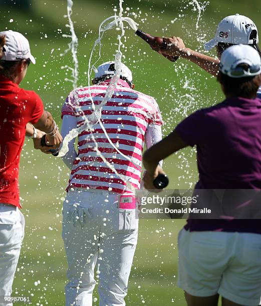 Na Yeon Choi of South Korea is drenched in beer by caddie Chiayu Lin, Yani Tseng, and Song-Hee Kim after her -16 under par victory during the final...