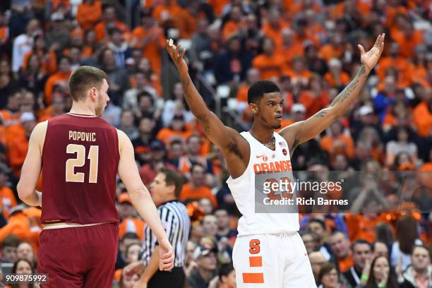 Frank Howard of the Syracuse Orange gestures to the crowd as Nik Popovic of the Boston College Eagles looks on during the first half at the Carrier...