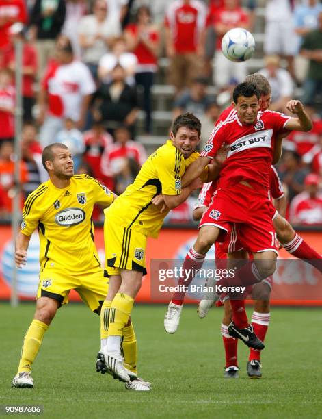 Alejandro Moreno and Danny O'Rourke of the Columbus Crew and Marco Pappa of the Chicago Fire go for the ball during the first half at Toyota Park on...