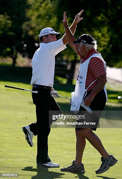 Fran Quinn high fives his caddie after hitting his second shot on the 18th hole to four feet setting up a winning birdie putt during the final round...