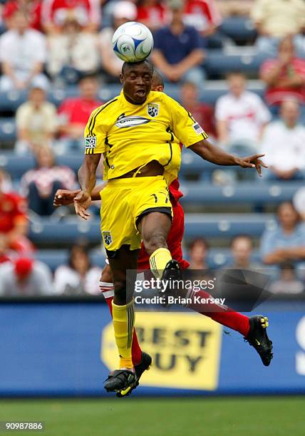 Emmanuel Ekpo of the Columbus Crew and Mike Banner of the Chicago Fire go for a header during the first half at Toyota Park on September 20, 2009 in...