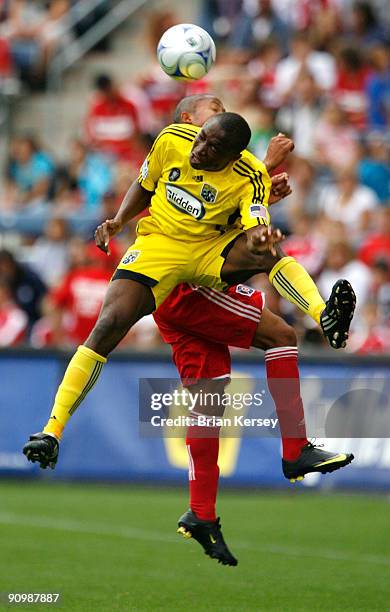 Emmanuel Ekpo of the Columbus Crew and Mike Banner of the Chicago Fire go for a header during the first half at Toyota Park on September 20, 2009 in...