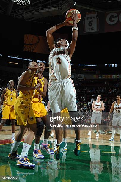 Swin Cash of the Seattle Storm goes to the basket against Tina Thopson and Lisa Leslie of the Los Angeles Sparks during Game Three of the WNBA...