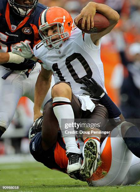 Quarterback Brady Quinn of the Cleveland Browns is sacked by defensive end Elvis Dumervil of the Denver Broncos in the fourth quarter during NFL...