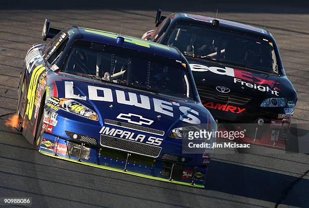 Jimmie Johnson, driver of the Lowe's Chevrolet, leads Denny Hamlin, driver of the FedEx Freight Toyota, during the NASCAR Sprint Cup Series Sylvania...
