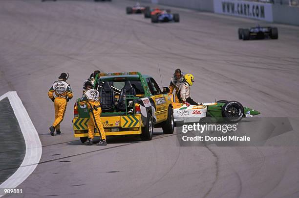 The Simple Green Safety Team helps Christian Fittipaldi after his Newman Haas Racing Toyota Lola crashed during the Grand Prix of Chicago round 7 of...