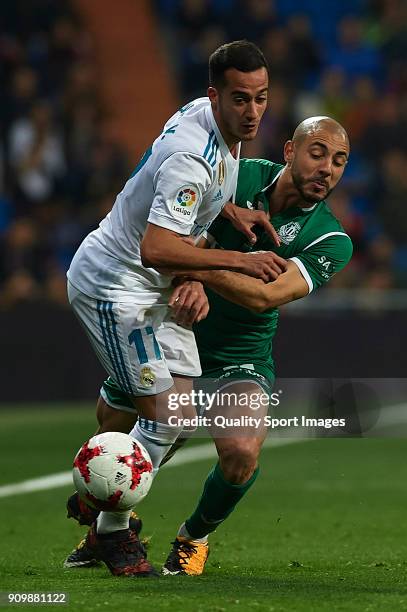 Isco of Real Madrid competes for the ball with Nordin Amrabat of Leganes during the Spanish Copa del Rey Quarter Final Second Leg match between Real...