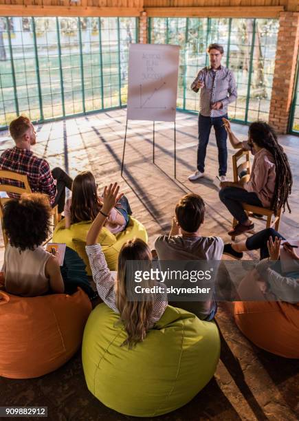 rear view of a businesswoman wants to ask something on presentation at casual office. - training bean bag stock pictures, royalty-free photos & images