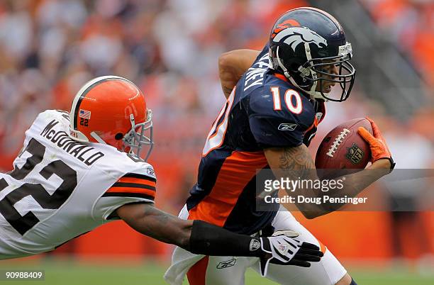 Wide receiver Jabar Gaffney of the Denver Broncos makes a reception and as Brandon McDonald of the Cleveland Browns defends during NFL action at...