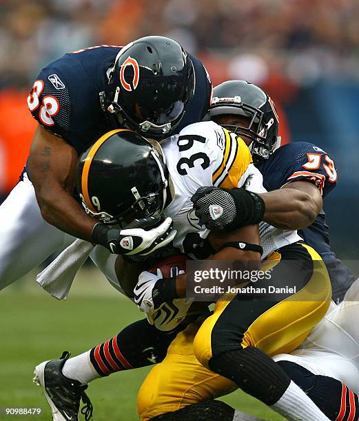 Danieal Manning and Nick Roach of the Chicago Bears bring down Willie Parker of the Pittsburgh Steelers on September 20, 2009 at Soldier Field in...