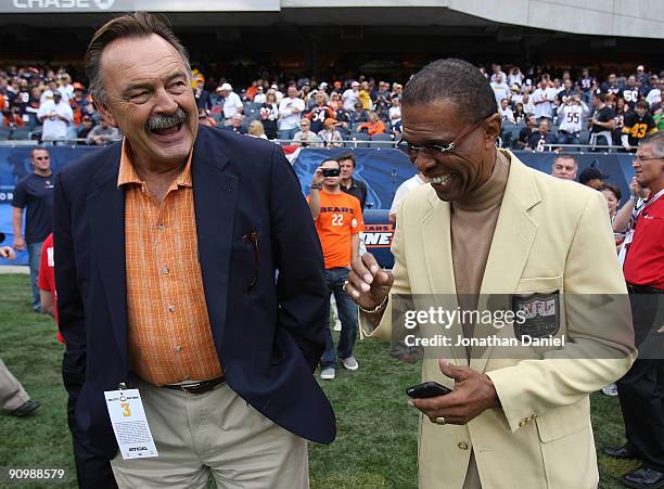 Hall of Fame Chicago Bears Dick Butkus and Gale Sayers share a laugh on the sidelines before a game between the Bears and the Pittsburgh Steelers on...