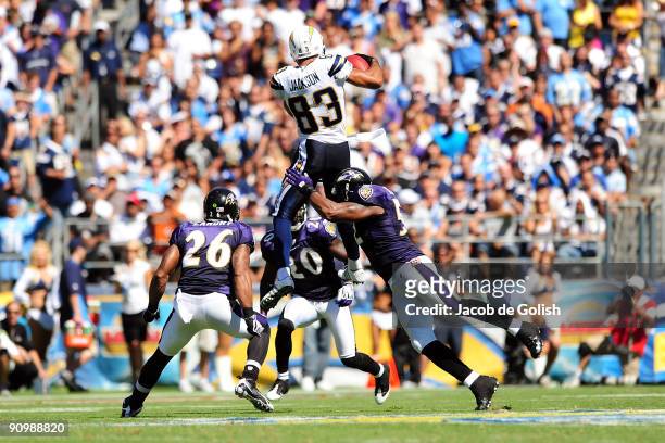 Vincent Jackson of the San Diego Chargers catches the ball against Ed Reed, and Dawan Landry of the Baltimore Ravens at Qualcomm Stadium on September...