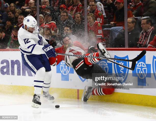 Connor Murphy of the Chicago Blackhawks hits the wall after chasing the puck with Patrick Marleau of the Toronto Maple Leafs at the United Center on...