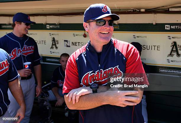 Manager Eric Wedge of the Cleveland Indians gets ready in the dugout before the game against the Oakland Athletics at the Oakland-Alameda County...