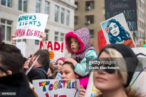 Child among placards at the 2018 Women's March in New York City on January 20, 2018.