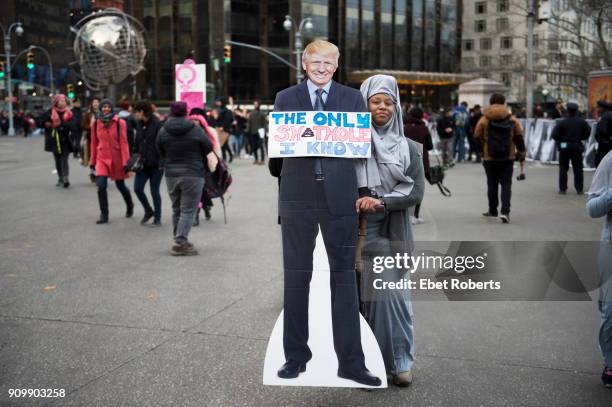 Marcher with standee of Donald Trump and a placard referring to alleged remarks by the US President, at the 2018 Women's March in New York City on...