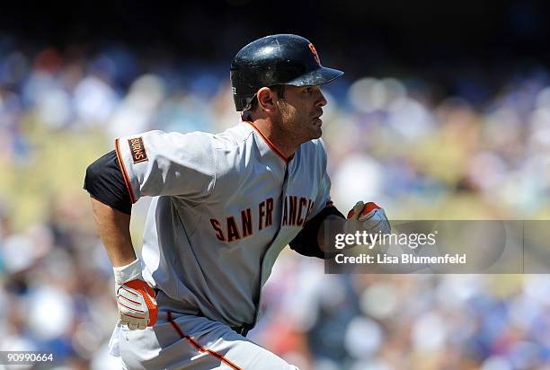 Freddy Sanchez of the San Francisco Giants runs to first base after hitting a single in the first inning against the Los Angeles Dodgers at Dodger...