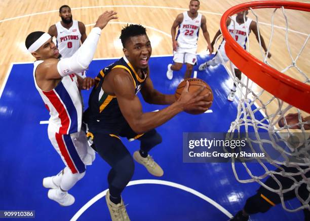 Donovan Mitchell of the Utah Jazz tries to get a shot off past Tobias Harris of the Detroit Pistons during the first half at Little Caesars Arena on...