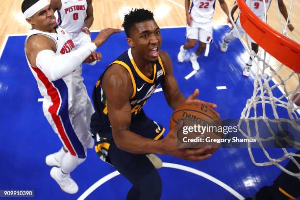 Donovan Mitchell of the Utah Jazz tries to get a shot off past Tobias Harris of the Detroit Pistons during the first half at Little Caesars Arena on...