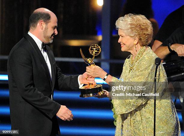 Writer Matthew Weiner accepts an award from actress Ellen Burstyn onstage at the 61st Primetime Emmy Awards held at the Nokia Theatre on September...