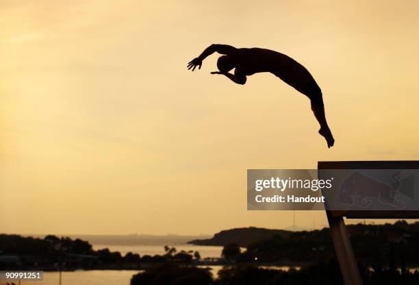 In this handout image provided by Ray Demski/Red Bull Photofiles, Artem Silchenko of Russia dives from the 26.5 metre platform during the eighth and...