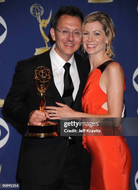 Actor Michael Emerson and wife actress Carrie Preston pose in the press room at the 61st Primetime Emmy Awards held at the Nokia Theatre on September...
