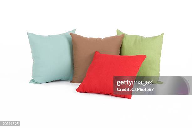 four different colored pillows - cushion stockfoto's en -beelden