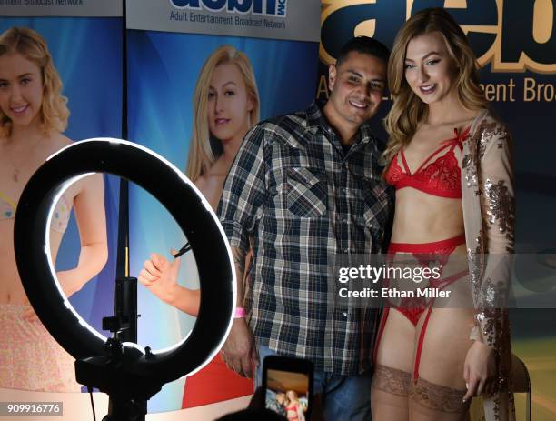 Roger Pereida of California poses for photos with adult film actress Alexa Grace at the Adult Entertainment Broadcast Network booth at the 2018 AVN...