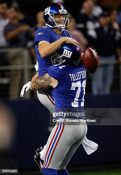 Kicker Lawrence Tynes of the New York Giants celebrates his game winning field goal with Dave Tollefson against the Dallas Cowboys at Cowboys Stadium...