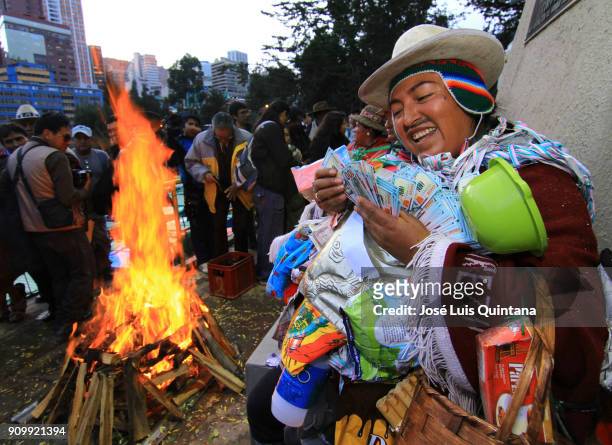 Man dressed as a Ekeko count money during the Alasitas festival on January 23, 2018 in La Paz, Bolivia. Alasitas festival which means "buy me" is an...