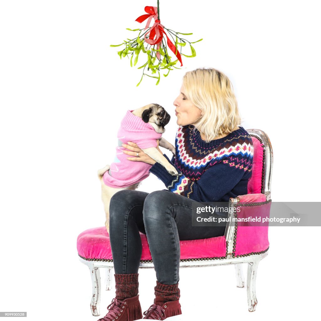 Adult with pug on chaise longue