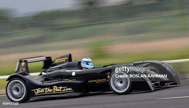 Twice Formula One world champion driver Mika Hakkinen of Finland drives a high performance two seater Johnnie Walker super car in Singapore on...